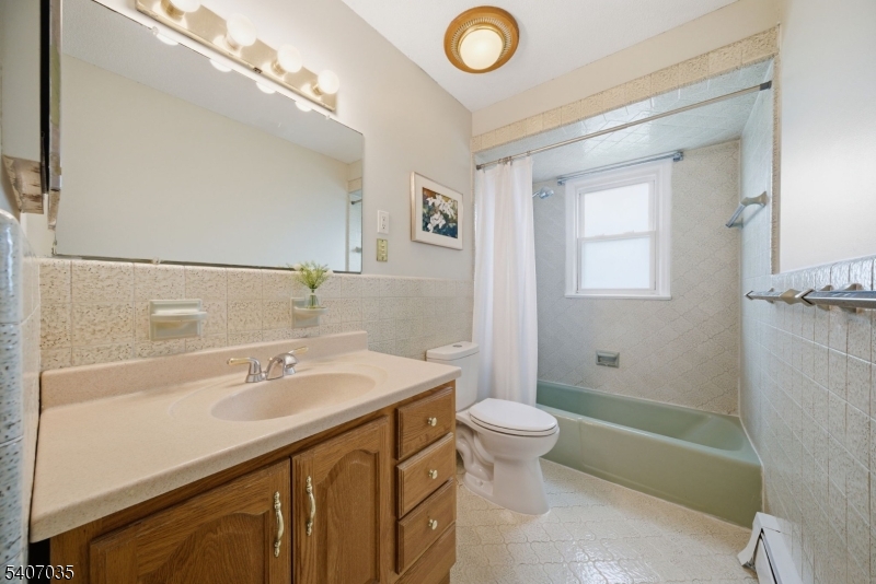 11 Deerfield Road Parsippany, NJ 07054 - Photo 17 of 42 a bathroom with a sink a toilet and shower