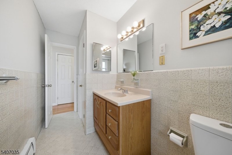 11 Deerfield Road Parsippany, NJ 07054 - Photo 18 of 42 a bathroom with a sink a toilet and a mirror