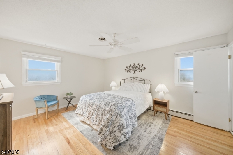 11 Deerfield Road Parsippany, NJ 07054 - Photo 19 of 42 a bedroom with a bed and wooden floor