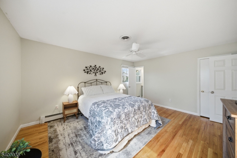 11 Deerfield Road Parsippany, NJ 07054 - Photo 20 of 42 a bedroom with a bed and a table in it