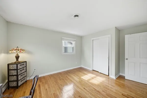 a bedroom with a bed and a night stand