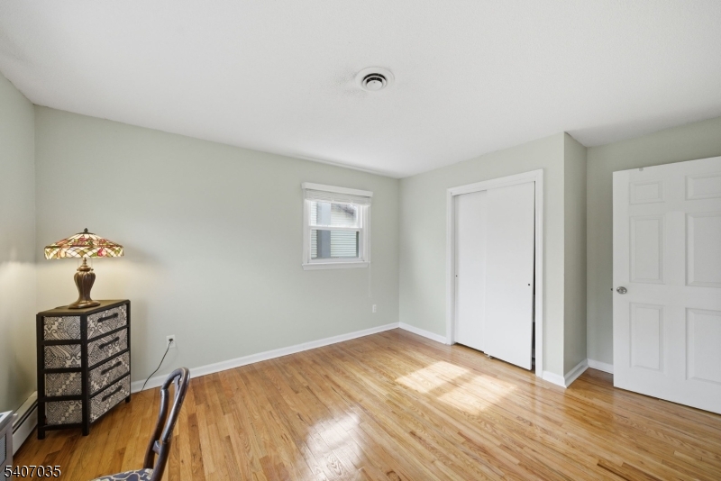 11 Deerfield Road Parsippany, NJ 07054 - Photo 25 of 42 a bedroom with a bed and a window