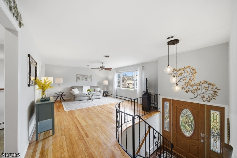 11 Deerfield Road Parsippany, NJ 07054 - Photo 28 of 42 a living room with furniture a chandelier and a wooden floor