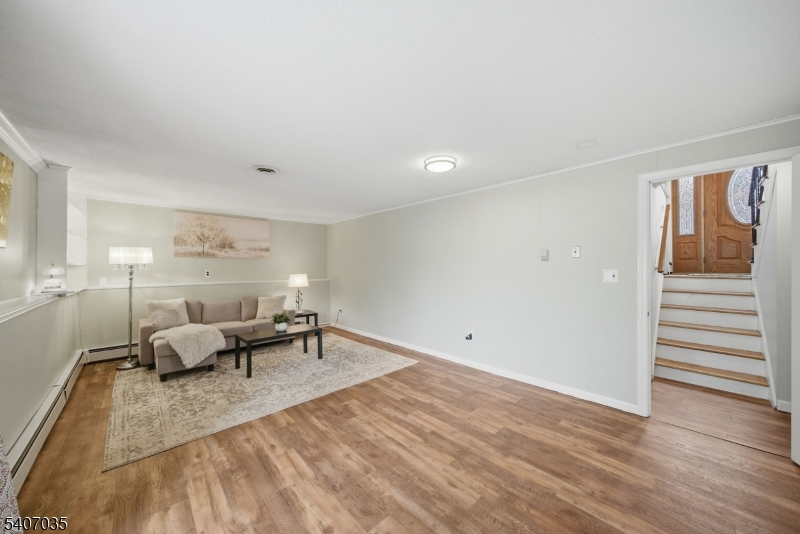 11 Deerfield Road Parsippany, NJ 07054 - Photo 31 of 42 a living room with furniture and wooden floor