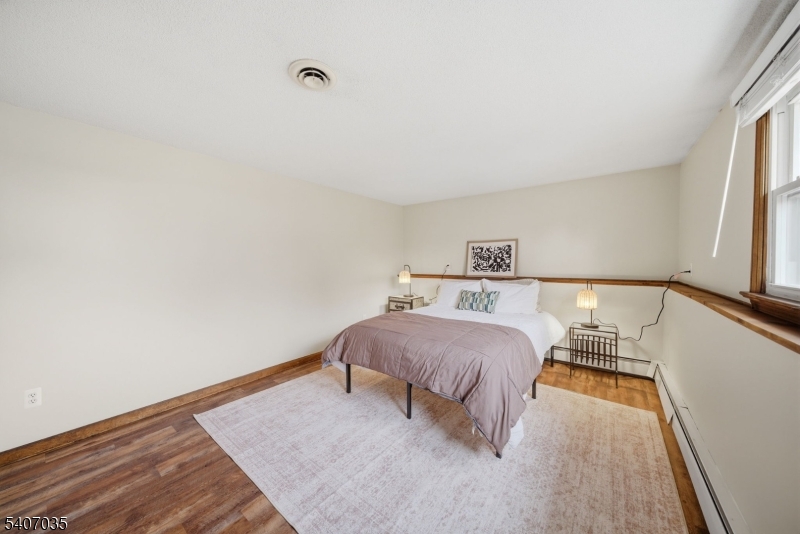 11 Deerfield Road Parsippany, NJ 07054 - Photo 34 of 42 a bedroom with a bed and a night stand