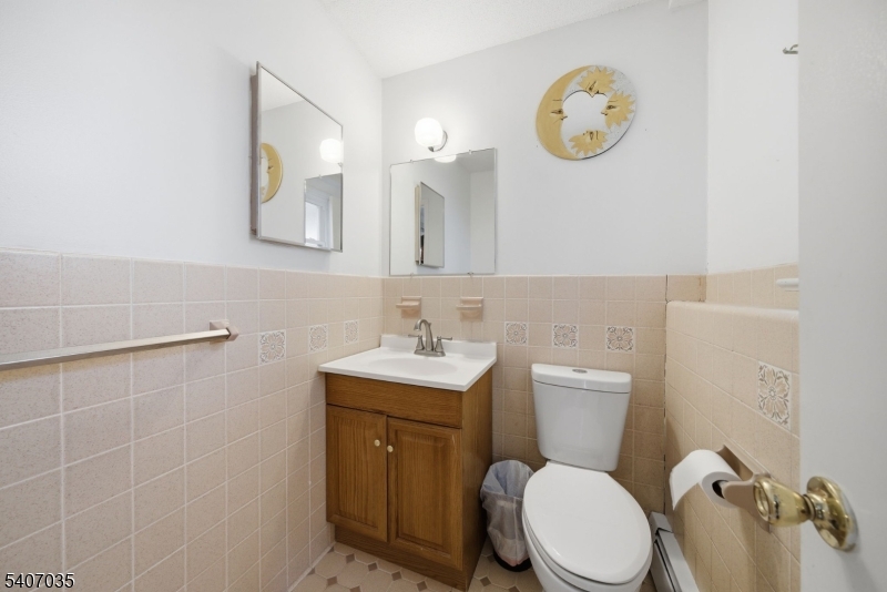 11 Deerfield Road Parsippany, NJ 07054 - Photo 38 of 42 a bathroom with a toilet a sink and mirror