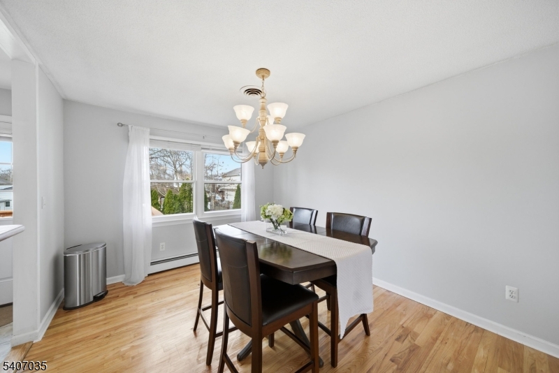11 Deerfield Road Parsippany, NJ 07054 - Photo 7 of 42 a view of a dining room with furniture a chandelier and wooden floor