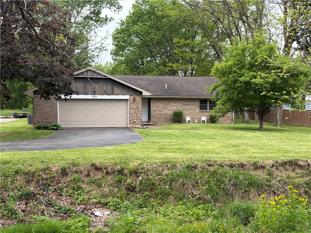 7225 Garber Road Clayton, OH 45415 - Photo 1 of 33 This charming residence features a brick exterior, an attached garage, and a lush, expansive front yard.