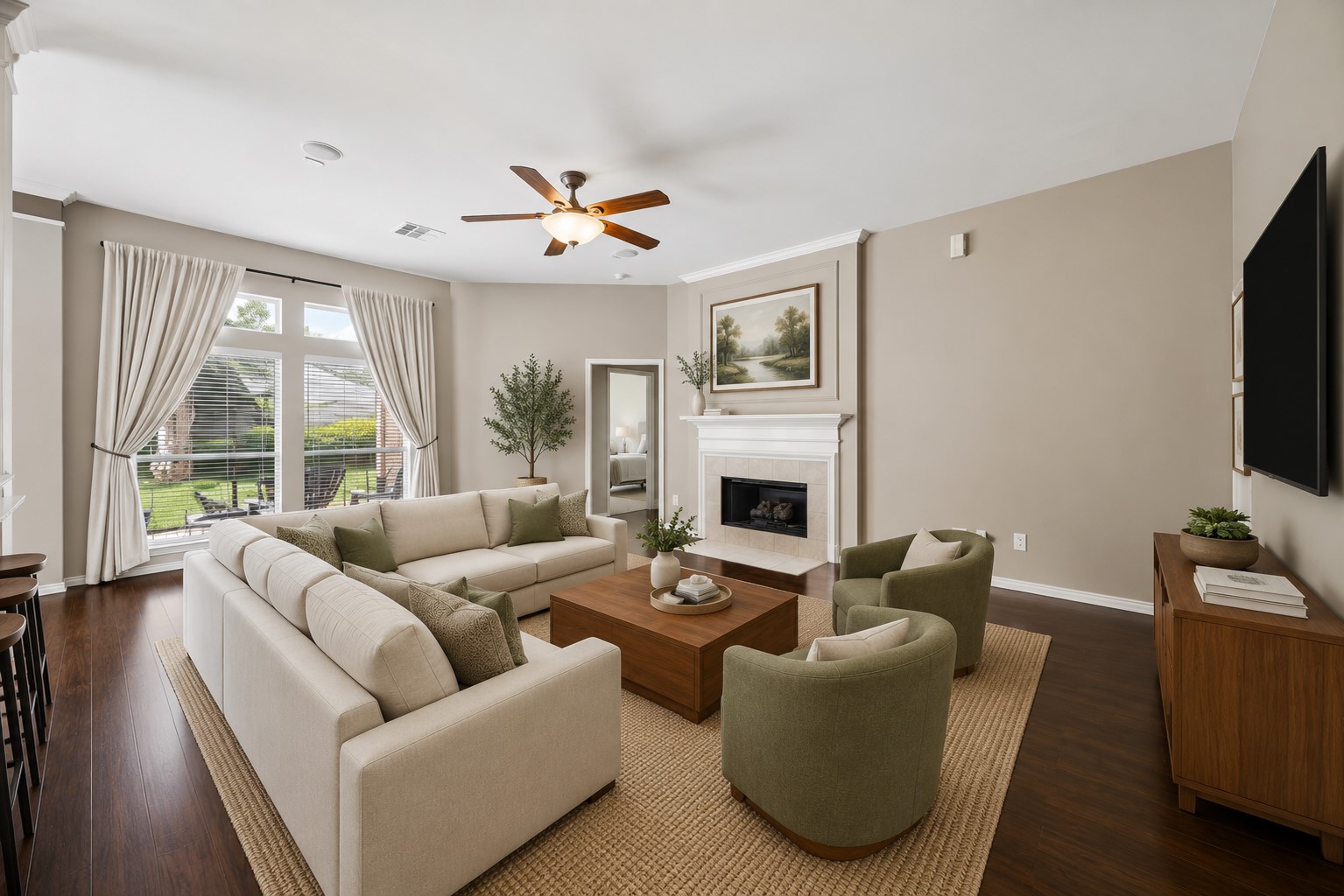 3118 Valley Court Manvel, TX 77578 - Photo 6 of 38 This virtual staged spacious living room features a cozy fireplace, elegant neutral decor, and ample natural light from large windows. It includes a comfortable seating area with a sectional sofa and armchairs, perfect for relaxation and entertaining.