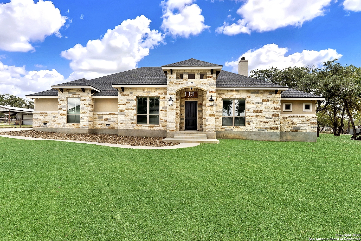 a front view of a house with a garden