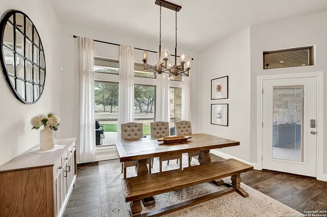 a living room with furniture a dining table and a large window