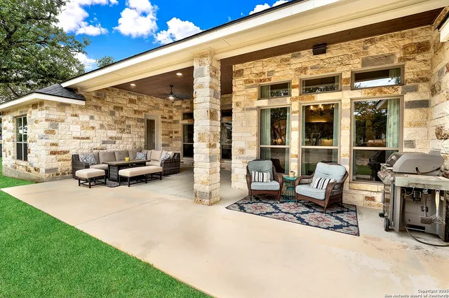 a building outdoor space with patio furniture and potted plants