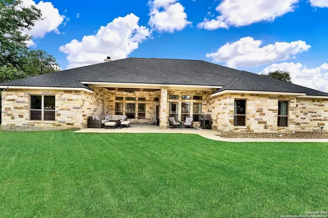 a view of a house with backyard porch and patio