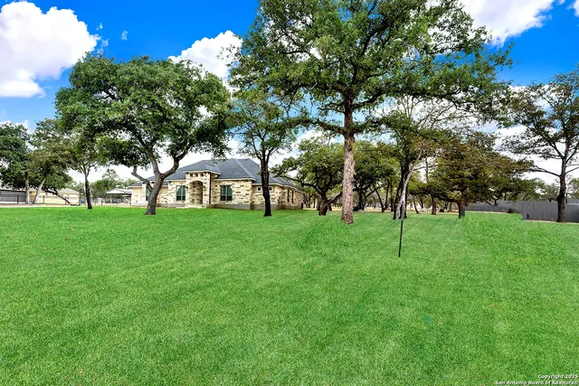 a view of house with backyard