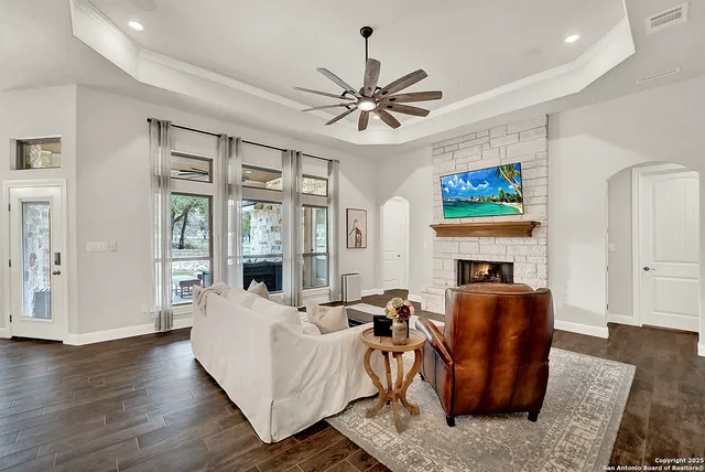 a living room with furniture a fireplace and a flat screen tv