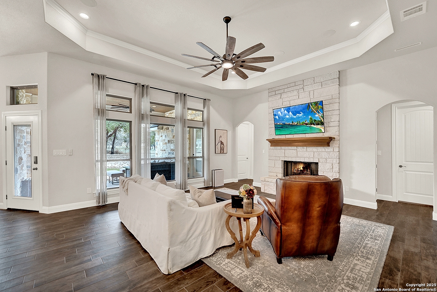 173 Hidden Pond Adkins, TX 78101 - Photo 6 of 40 a living room with furniture a fireplace and a flat screen tv