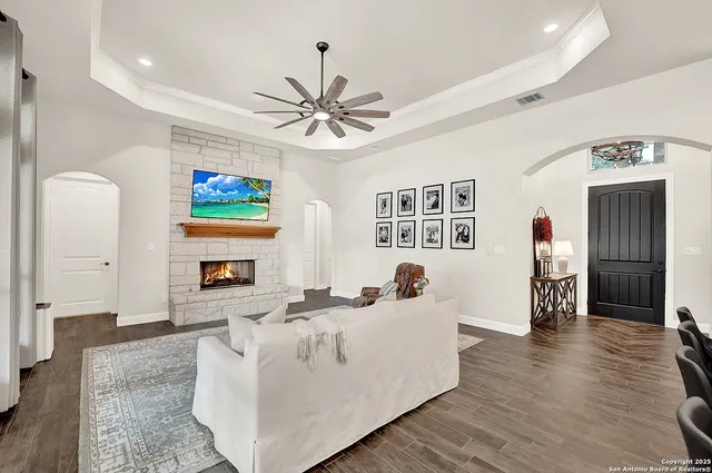 a living room with fireplace furniture and a flat screen tv