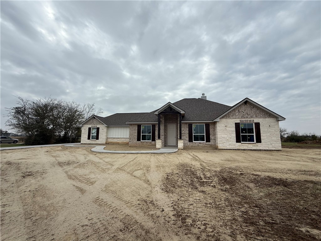 3245 Hunters Crossing Bryan, TX 77808 - Photo 14 of 26 a front view of a house with a yard