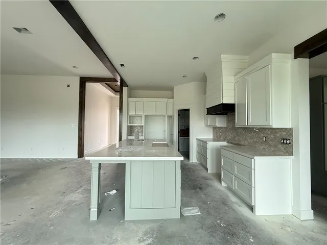 a kitchen with stainless steel appliances kitchen island a sink stove and refrigerator