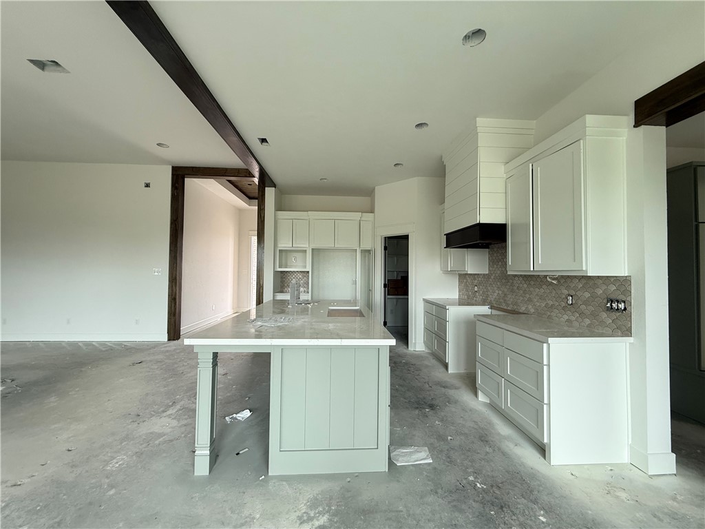 3245 Hunters Crossing Bryan, TX 77808 - Photo 18 of 26 a kitchen with stainless steel appliances kitchen island a sink stove and refrigerator