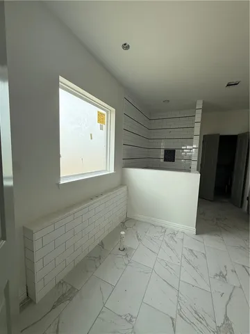 a view of a white bath tub sitting in a bathroom