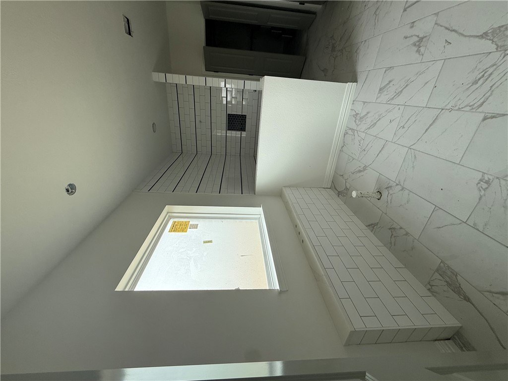 3245 Hunters Crossing Bryan, TX 77808 - Photo 23 of 26 a view of a white bath tub sitting in a bathroom