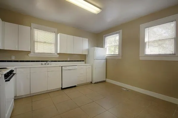 a kitchen with a sink cabinets and window