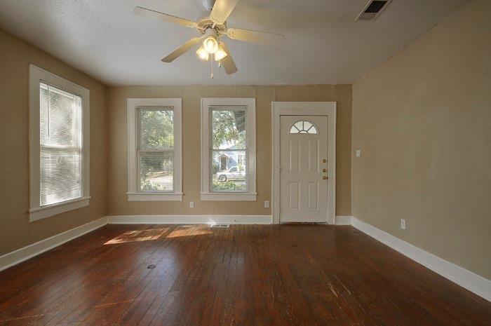 610 West 35th Street, Unit A Austin, TX 78705 - Photo 3 of 16 a view of an empty room with wooden floor and a window