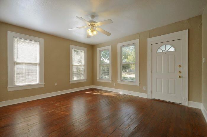 610 West 35th Street, Unit A Austin, TX 78705 - Photo 4 of 16 a view of an empty room with chandelier and wooden floor