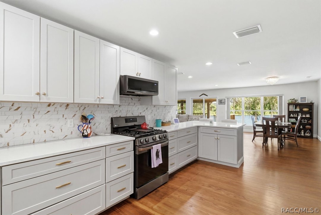 4099 West Ridge Court Dunnellon, FL 34433 - Photo 19 of 49 Another view from amazing kitchen. Nice breakfast bar with view of great room and the Waterfront paradise in your back yard. Please call and make appointment to see for yourself? You'll be overwelmed at the beauty!