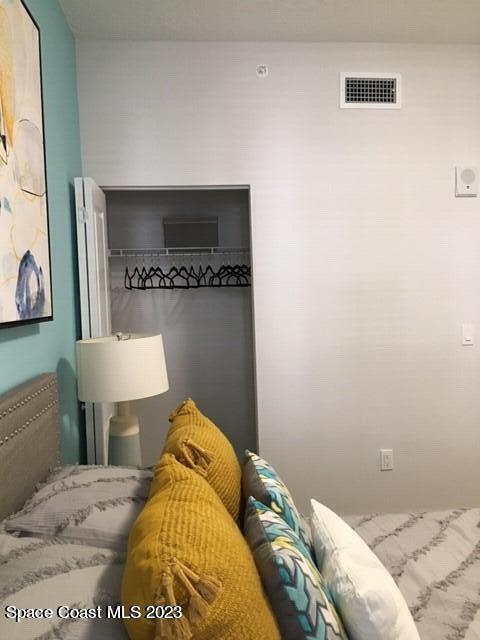 2785 Bosque Circle, Unit 303 Melbourne, FL 32940 - Photo 10 of 18 a bedroom with a bed and a lamp