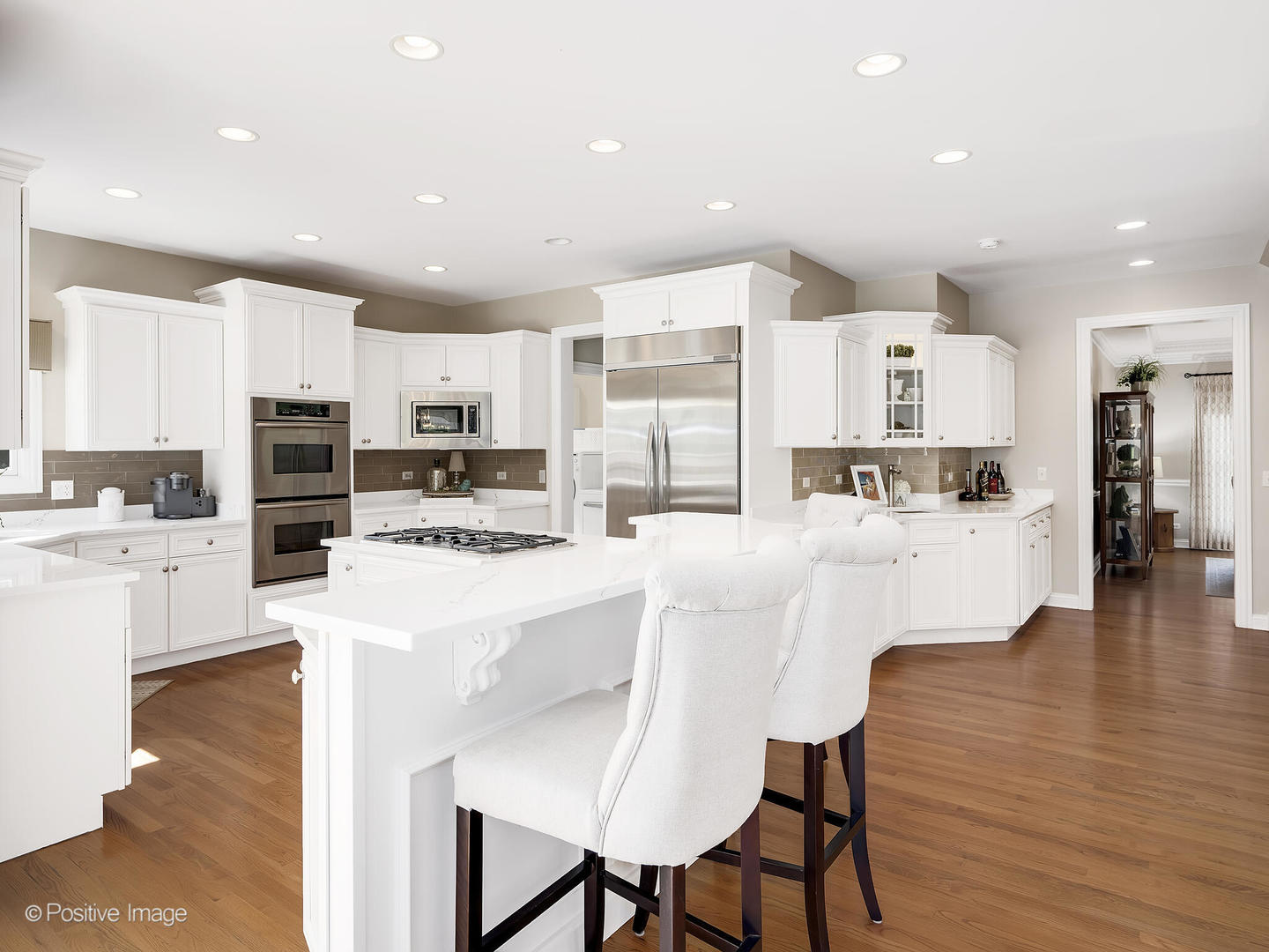 39-w740 Walt Whitman Road St. Charles, IL 60175 - Photo 11 of 39 a kitchen with stainless steel appliances kitchen island granite countertop a stove a refrigerator and white cabinets with wooden floor