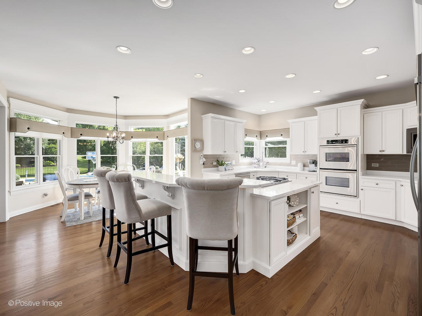 39-w740 Walt Whitman Road St. Charles, IL 60175 - Photo 10 of 39 a kitchen with stainless steel appliances granite countertop a stove top oven a refrigerator a dining table and chairs with wooden floor