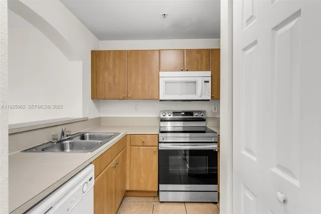 a kitchen with a sink stove and microwave