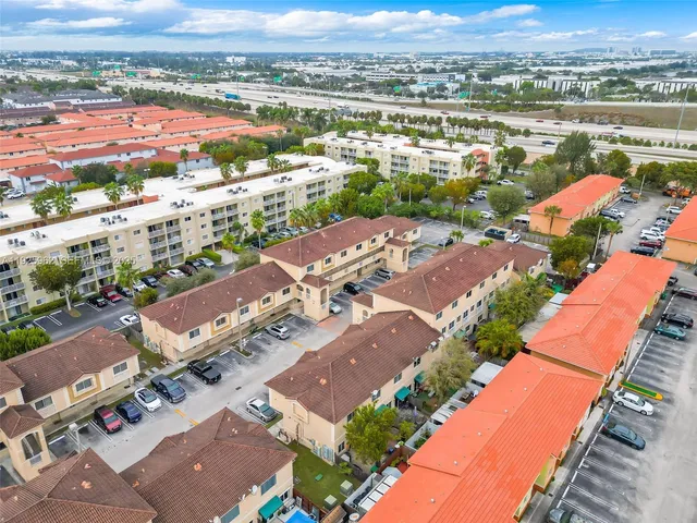 an aerial view of residential houses with outdoor space