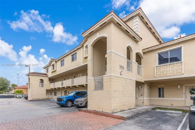 a car parked in front of white house