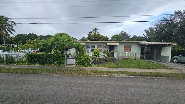 a front view of a house with a yard and a garage