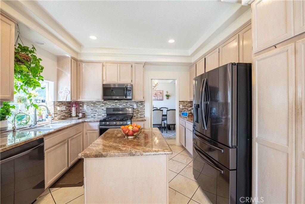 985 Brandon Avenue Simi Valley, CA 93065 - Photo 14 of 48 a kitchen with a refrigerator and a stove top oven