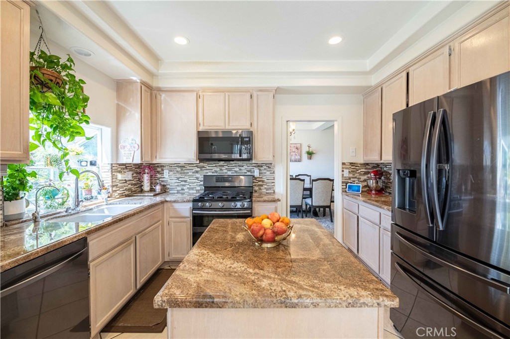 985 Brandon Avenue Simi Valley, CA 93065 - Photo 15 of 48 a view of a kitchen with kitchen island a counter top space a sink stainless steel appliances and cabinets