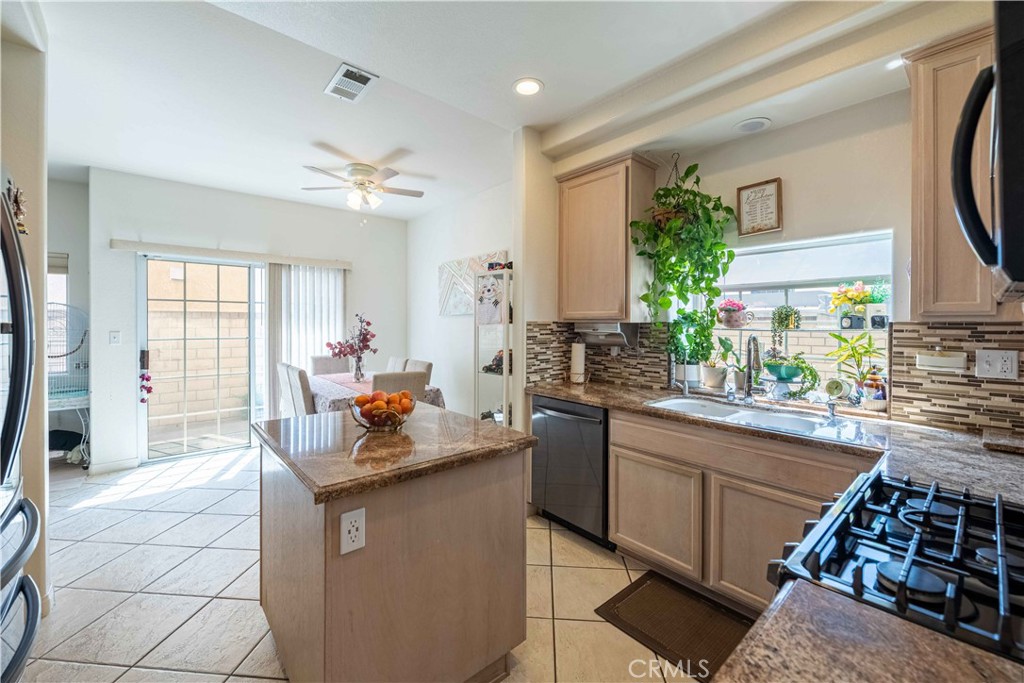 985 Brandon Avenue Simi Valley, CA 93065 - Photo 17 of 48 a kitchen with kitchen island granite countertop lots of counter top space and dining table