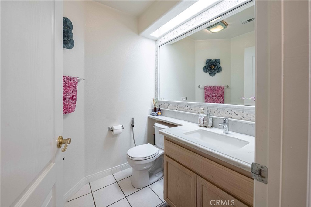985 Brandon Avenue Simi Valley, CA 93065 - Photo 18 of 48 a bathroom with a granite countertop toilet sink and mirror