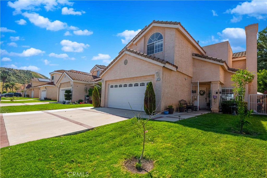 985 Brandon Avenue Simi Valley, CA 93065 - Photo 2 of 48 a front view of a house with a yard and garage