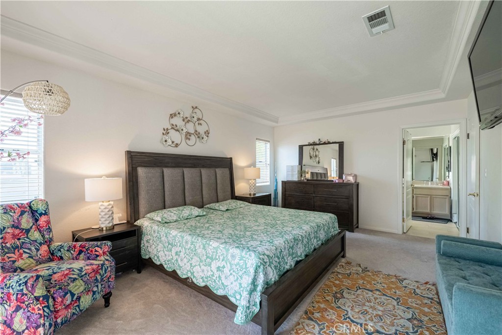 985 Brandon Avenue Simi Valley, CA 93065 - Photo 28 of 48 a bedroom with a bed and dresser with mirror