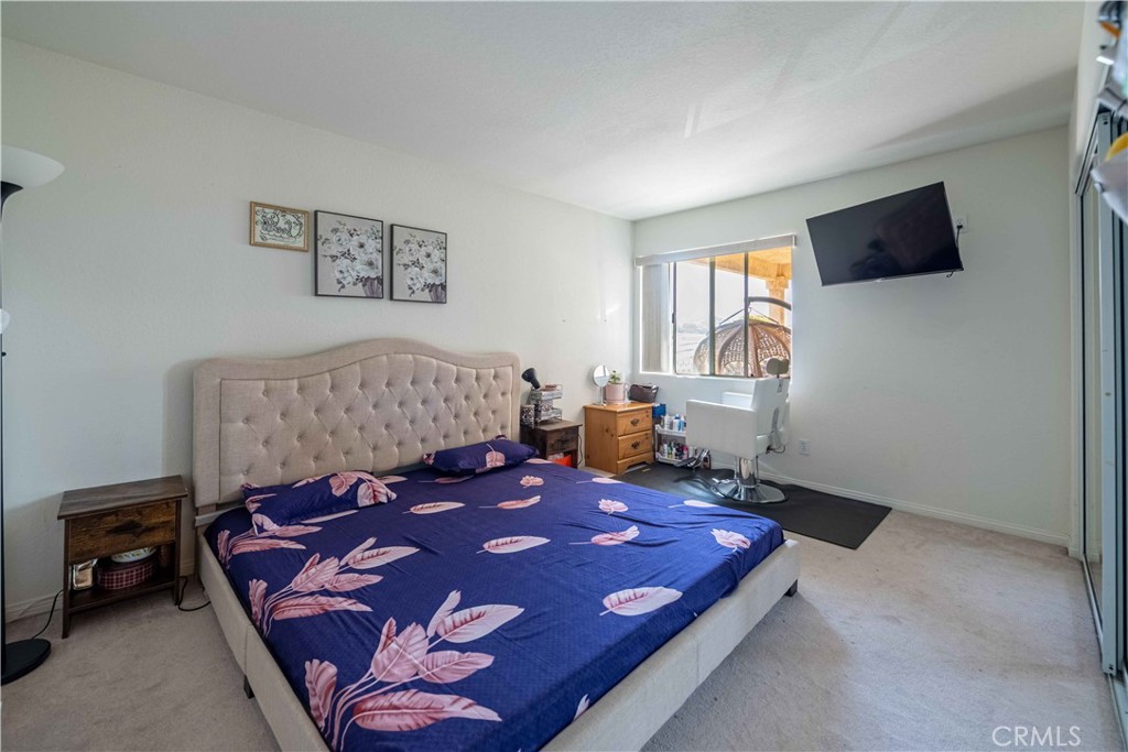 985 Brandon Avenue Simi Valley, CA 93065 - Photo 35 of 48 a bed room with a bed window and a flat screen tv