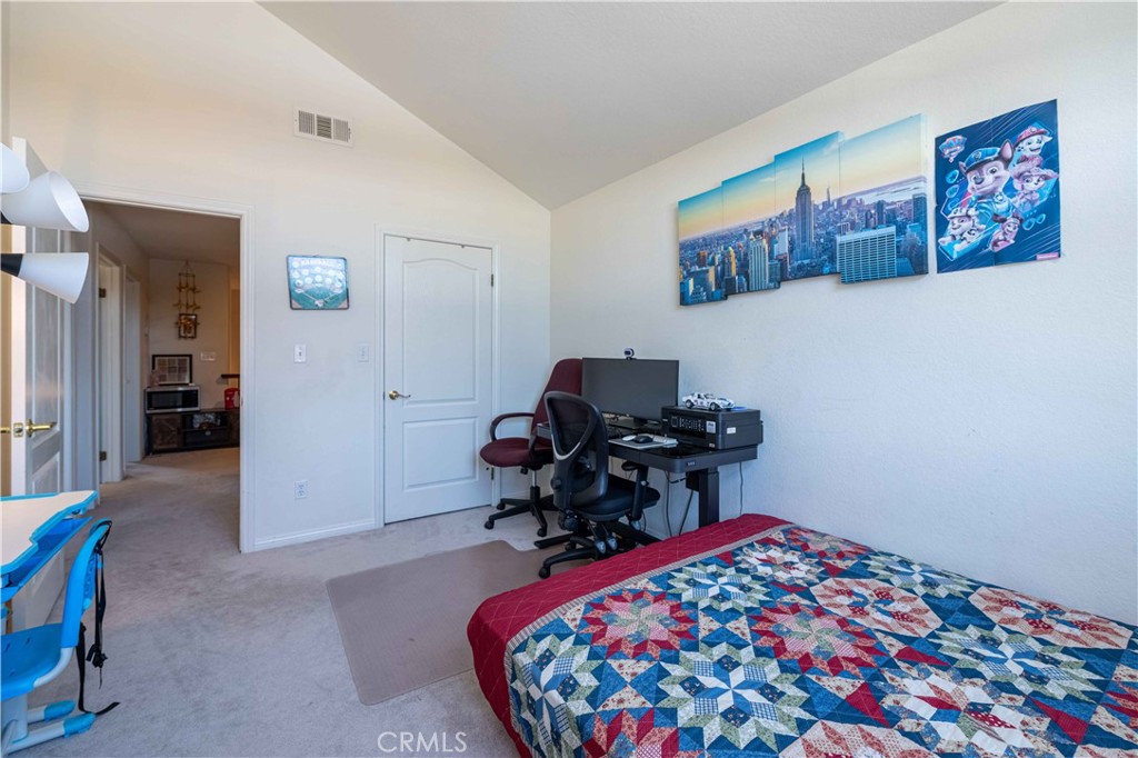985 Brandon Avenue Simi Valley, CA 93065 - Photo 40 of 48 a bedroom with a bed and a chair in it