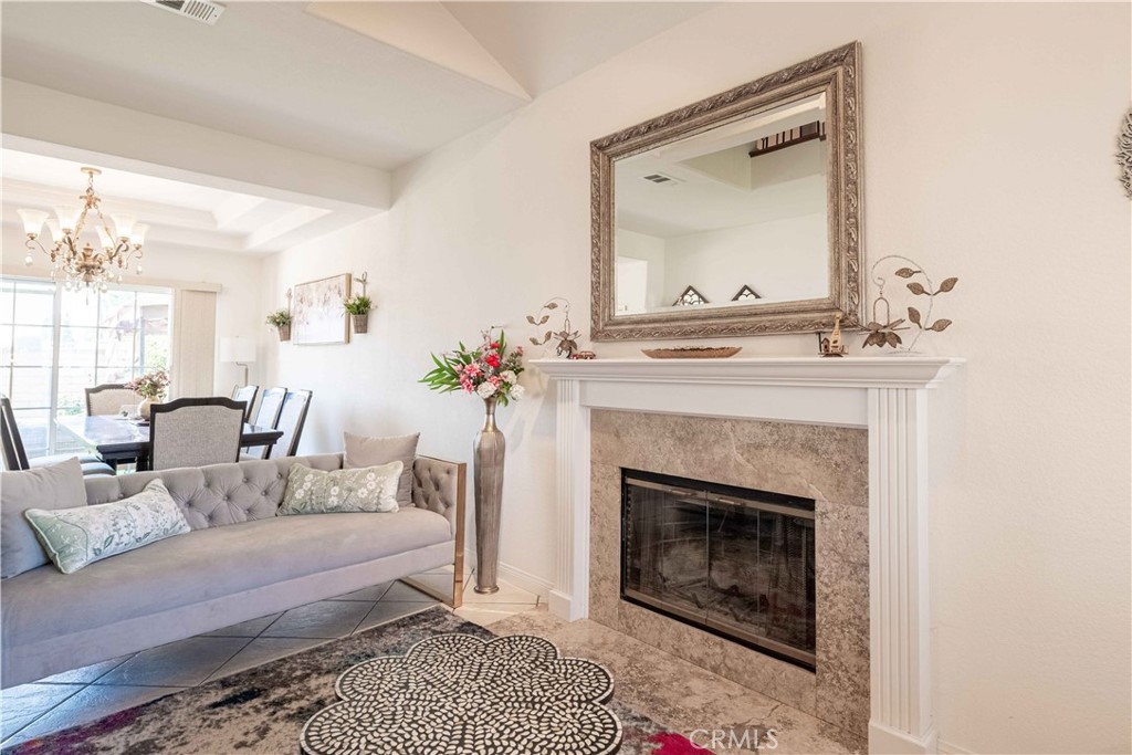 985 Brandon Avenue Simi Valley, CA 93065 - Photo 6 of 48 a living room with furniture a fireplace and a potted plant