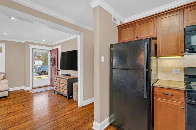 a kitchen with stainless steel appliances granite countertop a refrigerator and a stove top oven
