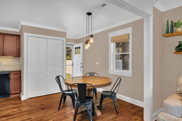 a view of a dining room with furniture and window