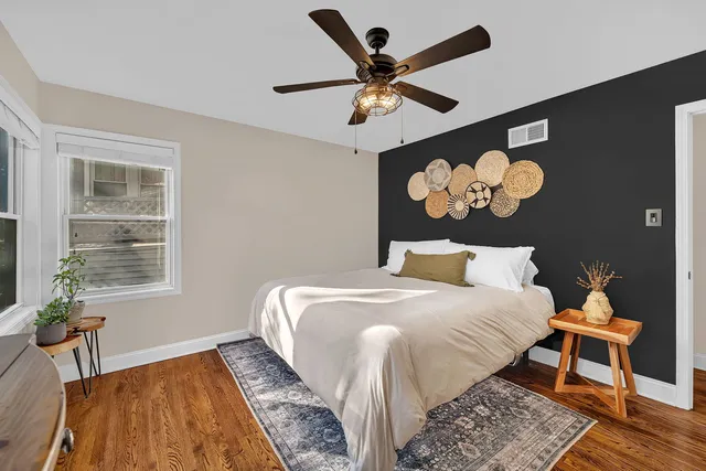 a bedroom with a bed and a window