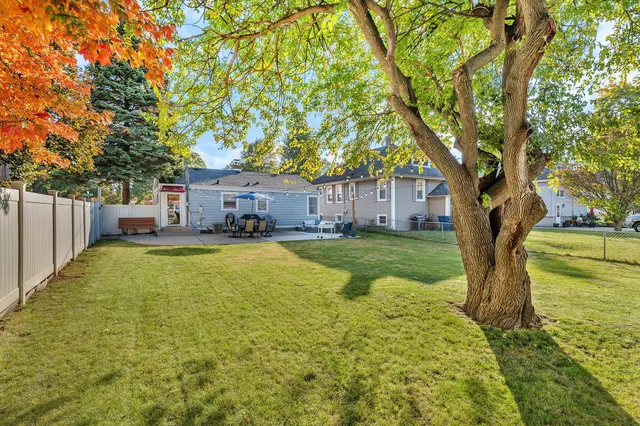 a view of a house with swimming pool and sitting area